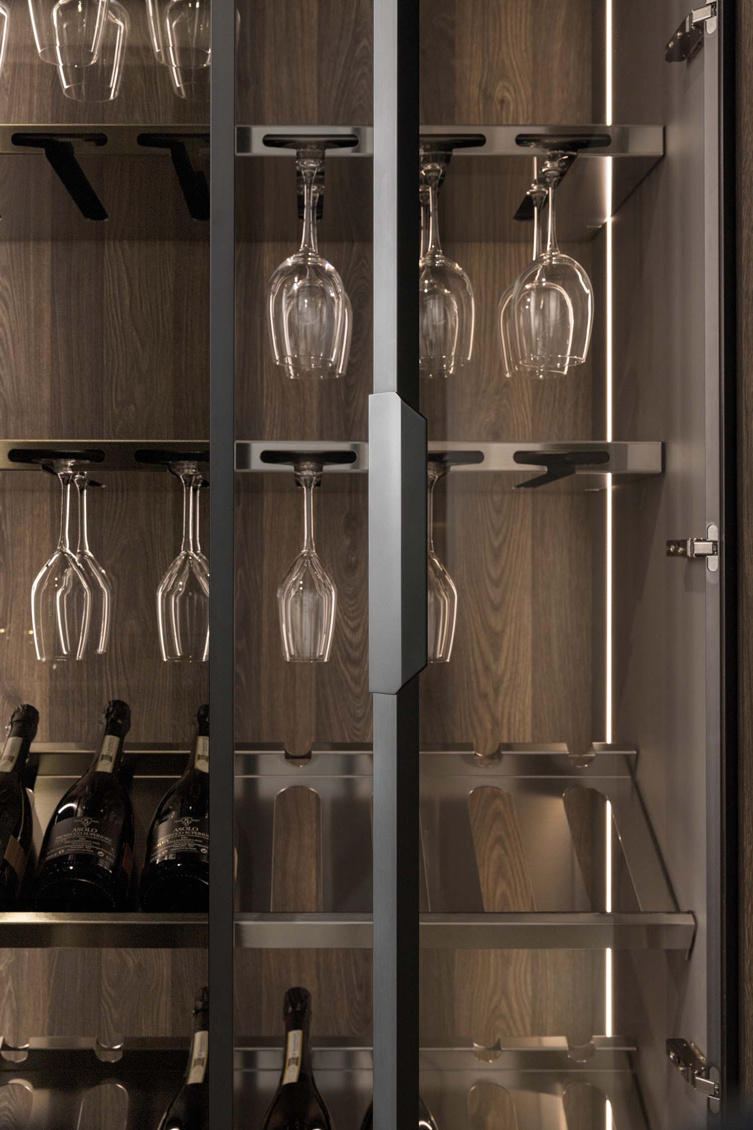 Luxury black-lit LED glass tall units finished with a complimentary oak veneer back panel and black aluminium frame surrounding elegant smoked glass. The perfect location for glassware and wine.
