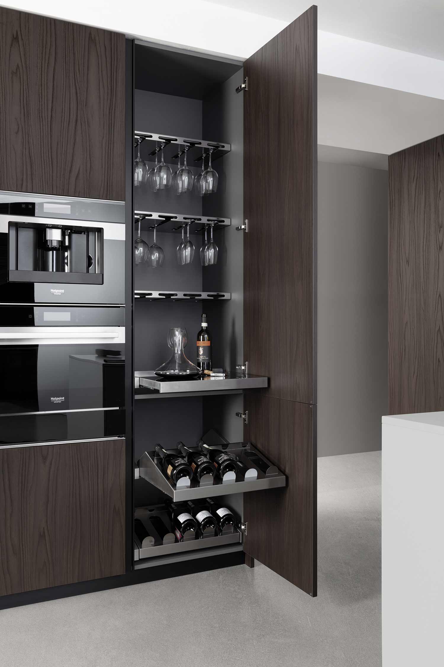 Wine glass holders , pouring table and pull-out bottle racks all equipped within the kitchen talll unit.