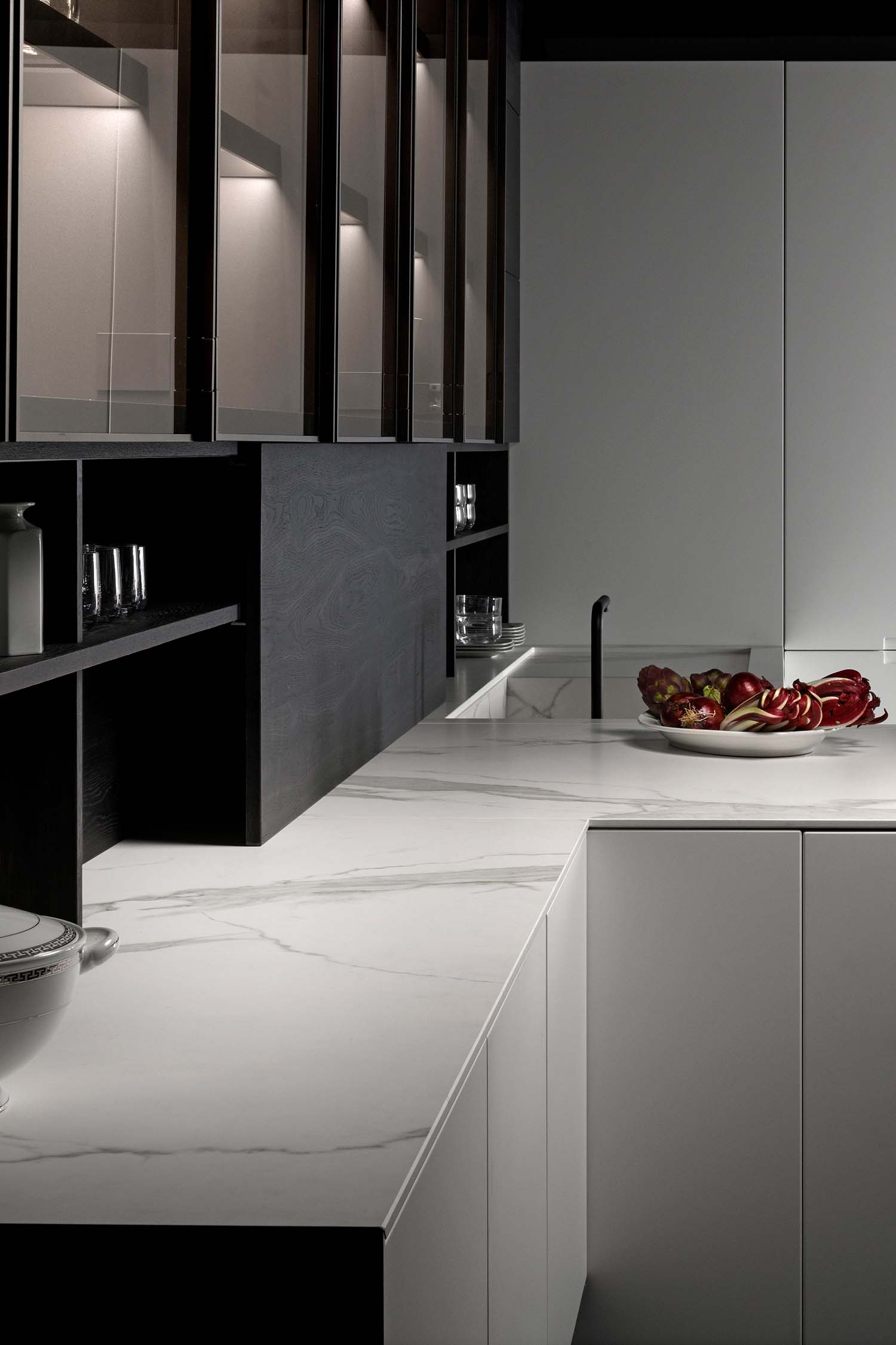 Luxury white Carrara Gres marble worktop in modern, handleless kitchen design.