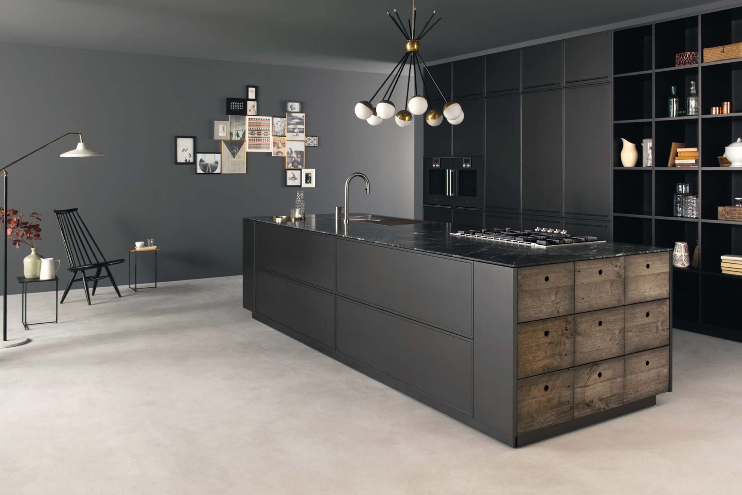 Luxury black industrial kitchen with black marble, matt black tray style doors by Krieder kitchens.