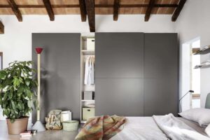 Luxury, minimal sliding wardrobe. Bedroom furniture made in Italy, designed and installed by Krieder UK.