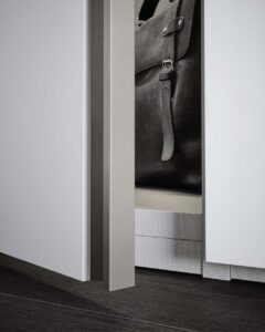 White fitted modular wardrobe units with luxury TV mounting panel. Designed and fitted by Krieder UK.