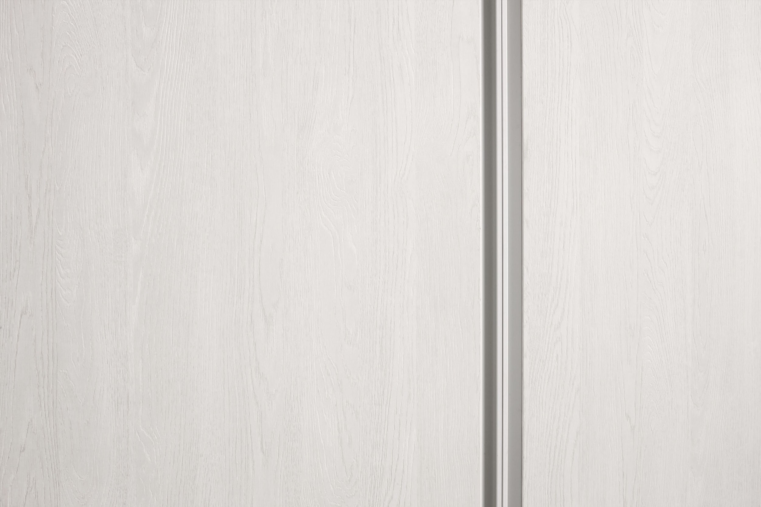 Luxury Italian sliding wardrobe with full-height handle grip. Available to be installed set against a wall, recessed or on a wall corner. Designed and install by Krieder