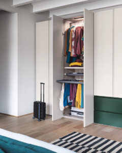 Luxury modern fitted wardrobe with external drawer unit combination bedroom furniture. Designed and fitted by Krieder in the UK.
