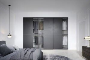Modern glass panel sliding wardrobe. Luxury wardrobes designed and installed by Krieder UK.