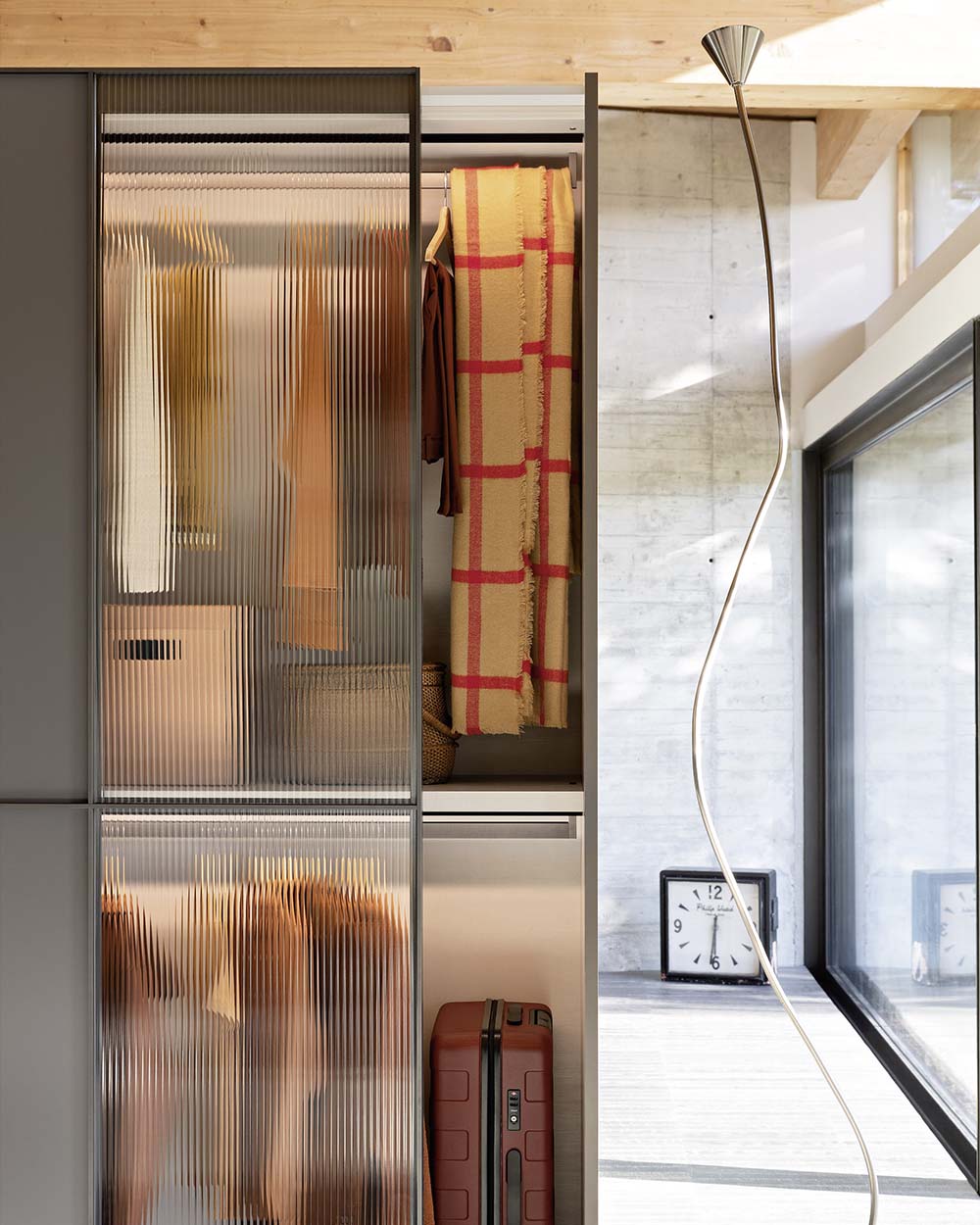 Modern, Italian sliding wardrobe with elegant glass panels, available with wired glass and smoked glass with matt lacquer. Designed and fitted by Krieder.