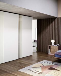 A luxury, modern and contemporary sliding wardrobe. Made in Italy with a choice of mirror, wood and matt lacquered finishes. Designed and installed by Krieder.