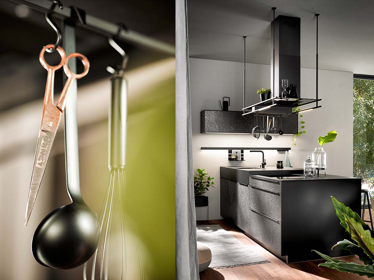 Small modern kitchen design with dark units and hanging storage accessories by Krieder UK