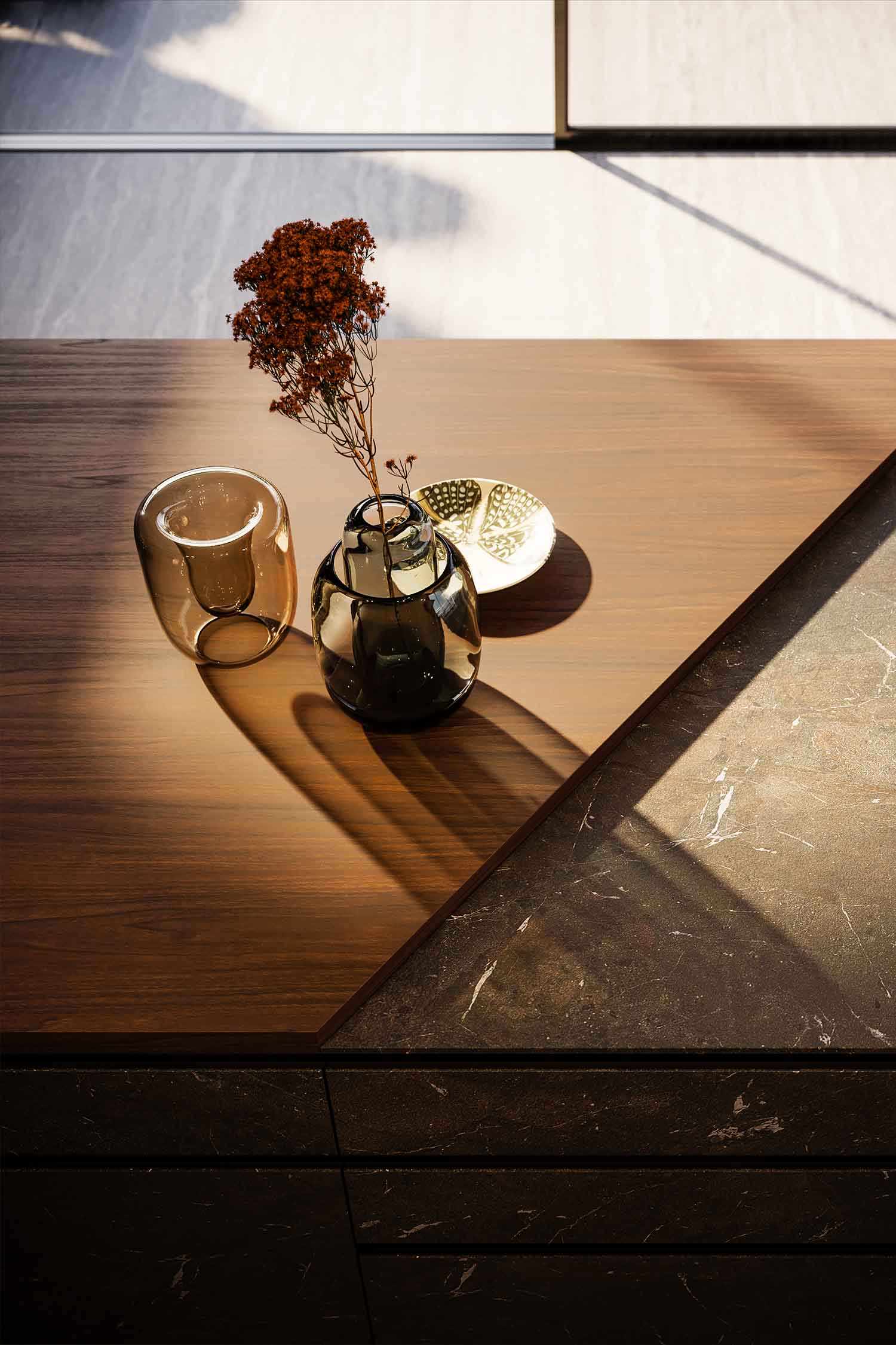 A detailed view of a minimalist sink and a sleek black faucet on a white countertop. The photo shows the seamless integration of the sink into the counter surface.