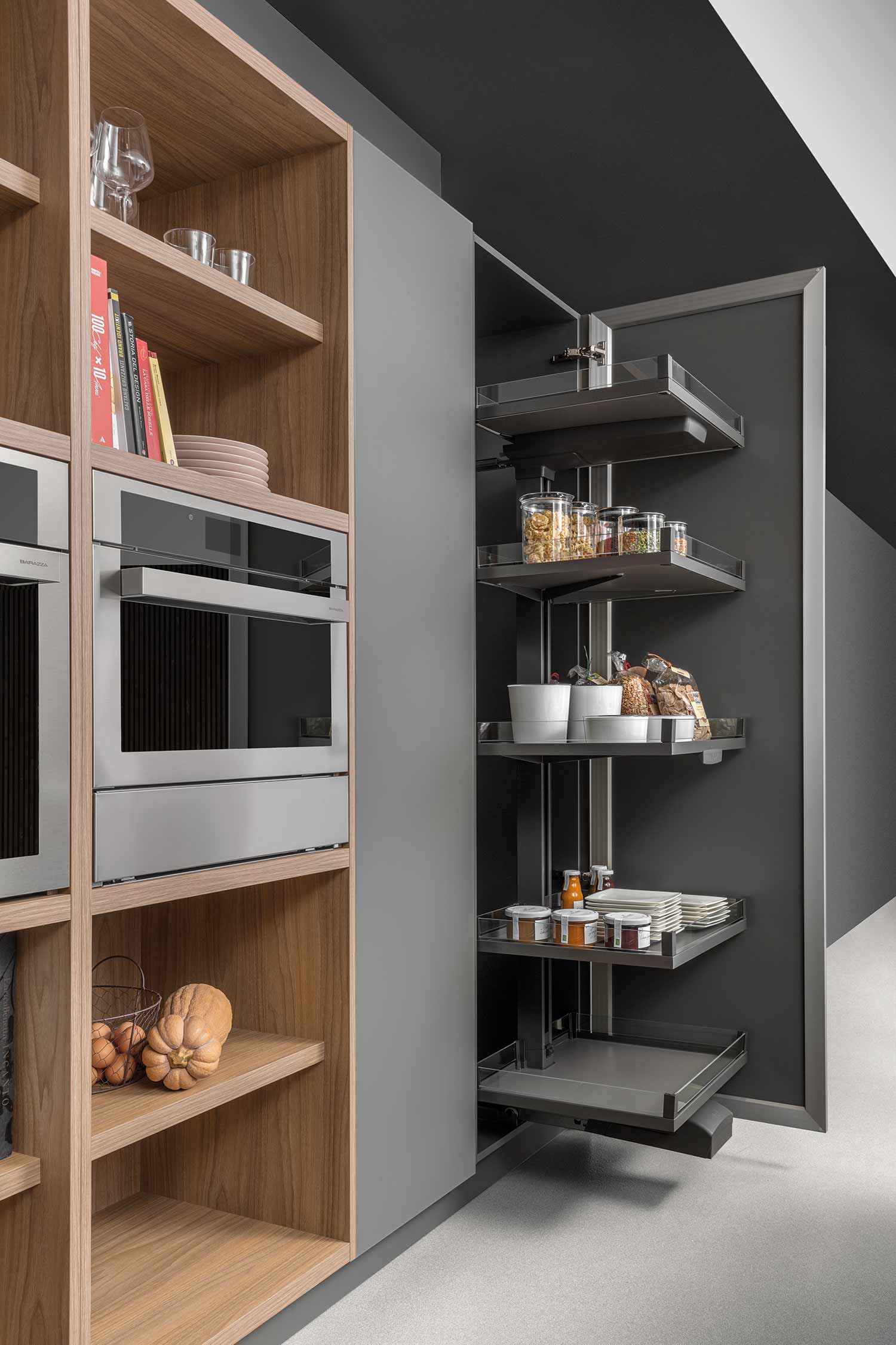 A detail shot of an open kitchen drawer, highlighting a bespoke wooden cutlery insert with organized compartments.