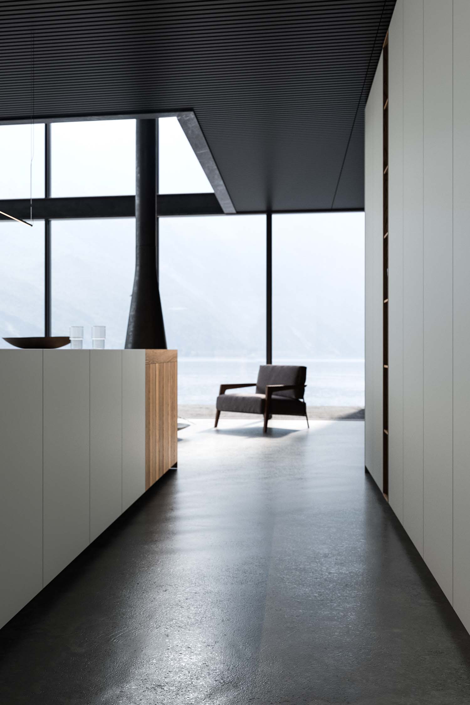 A close-up of a kitchen countertop made of light-colored stone with subtle grey veining. A modern, minimalist stovetop is integrated directly into the surface.