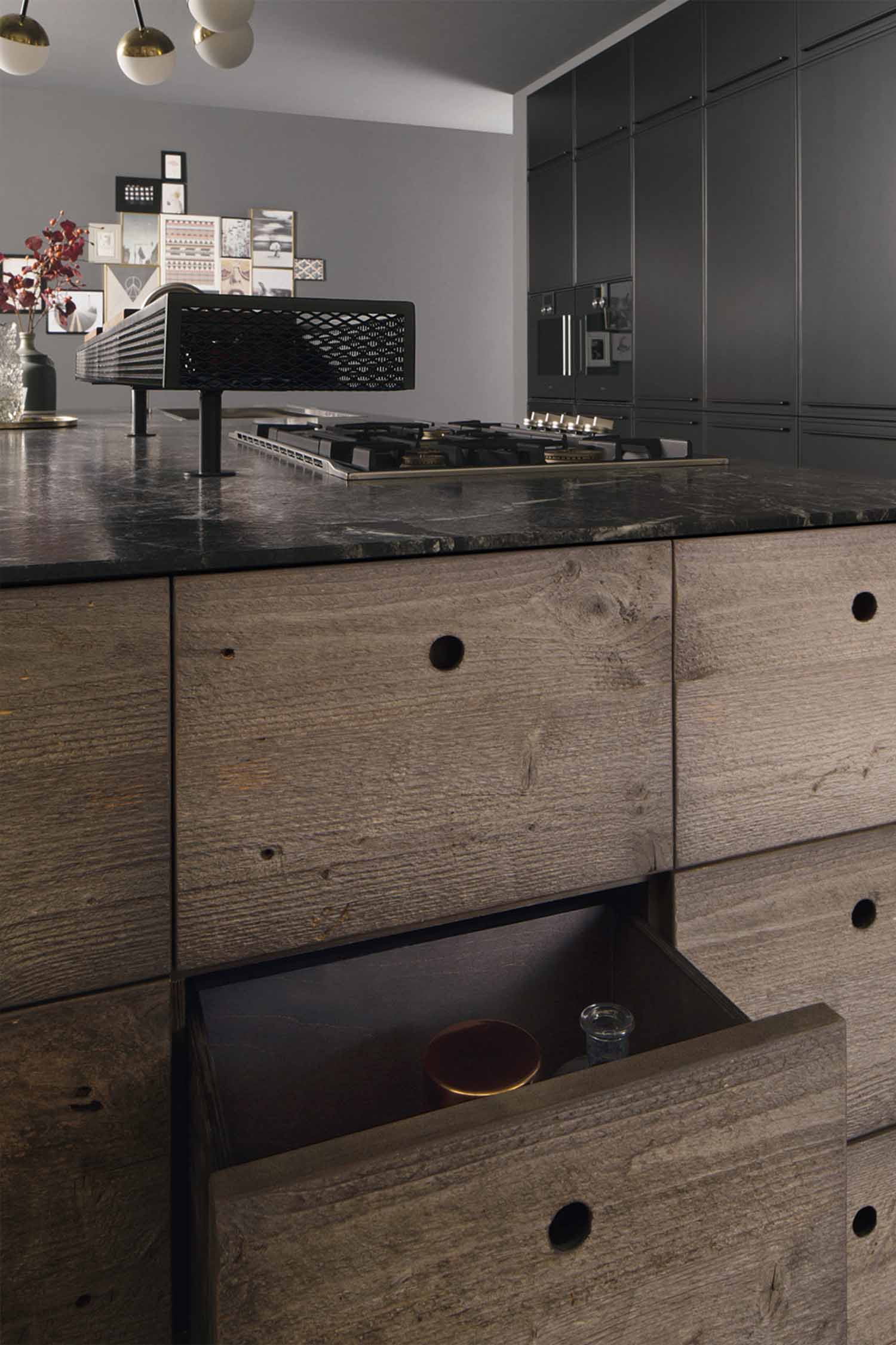 A close-up of a kitchen's open interior, revealing a bespoke wooden bottle rack and a small plant on a shelf.