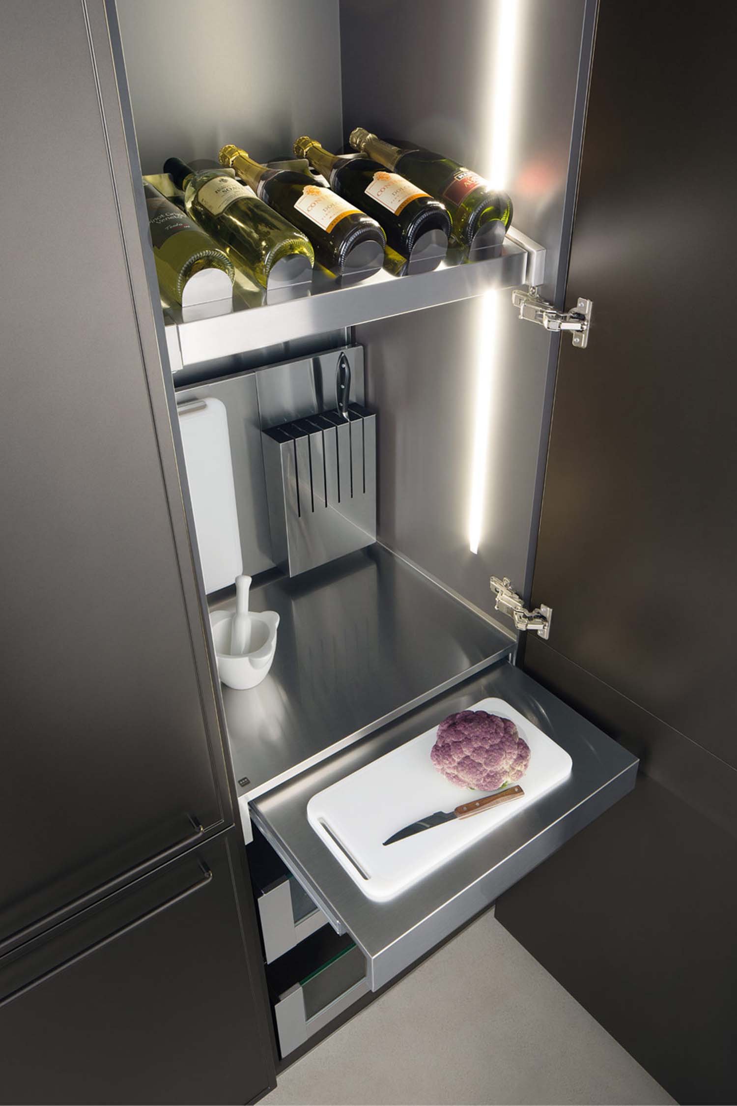 A close-up view of a minimalist, integrated kitchen faucet in a matte black finish, set against a dark grey stone countertop.