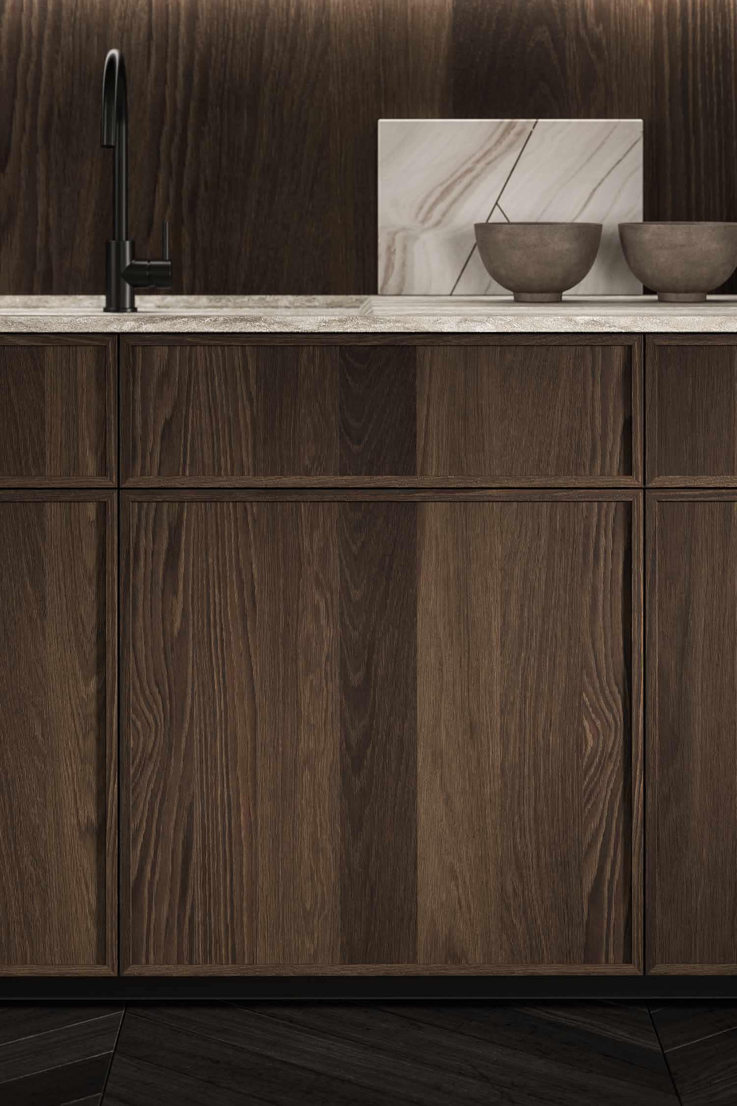 A detailed shot of a kitchen countertop with a subtle, dark stone texture and a black, integrated sink. A small, dark-colored object sits on the counter next to the sink.