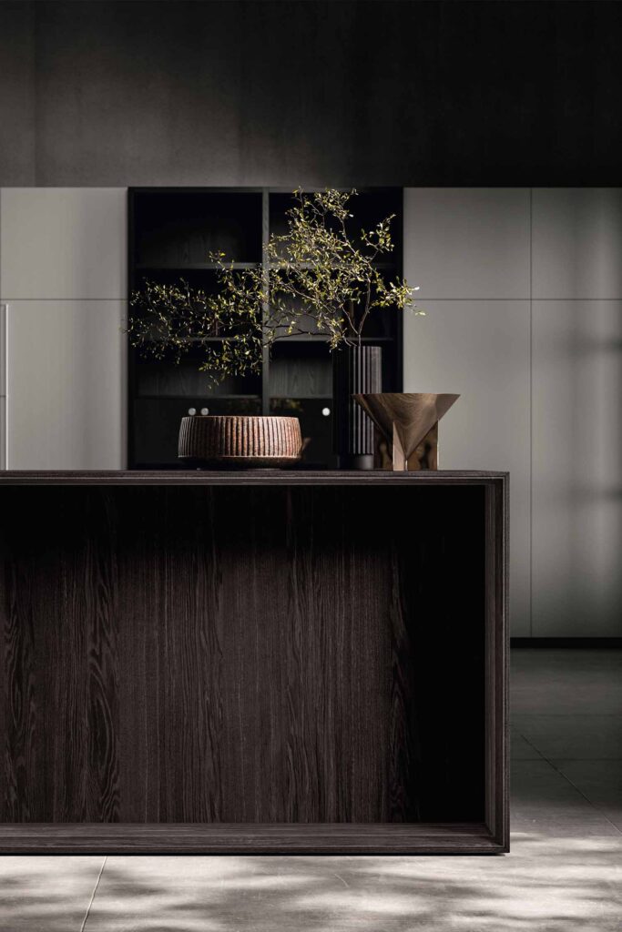 Muji Japandi-style luxury kitchen island in dark wood with minimalist shelving and natural light – Krieder Studio