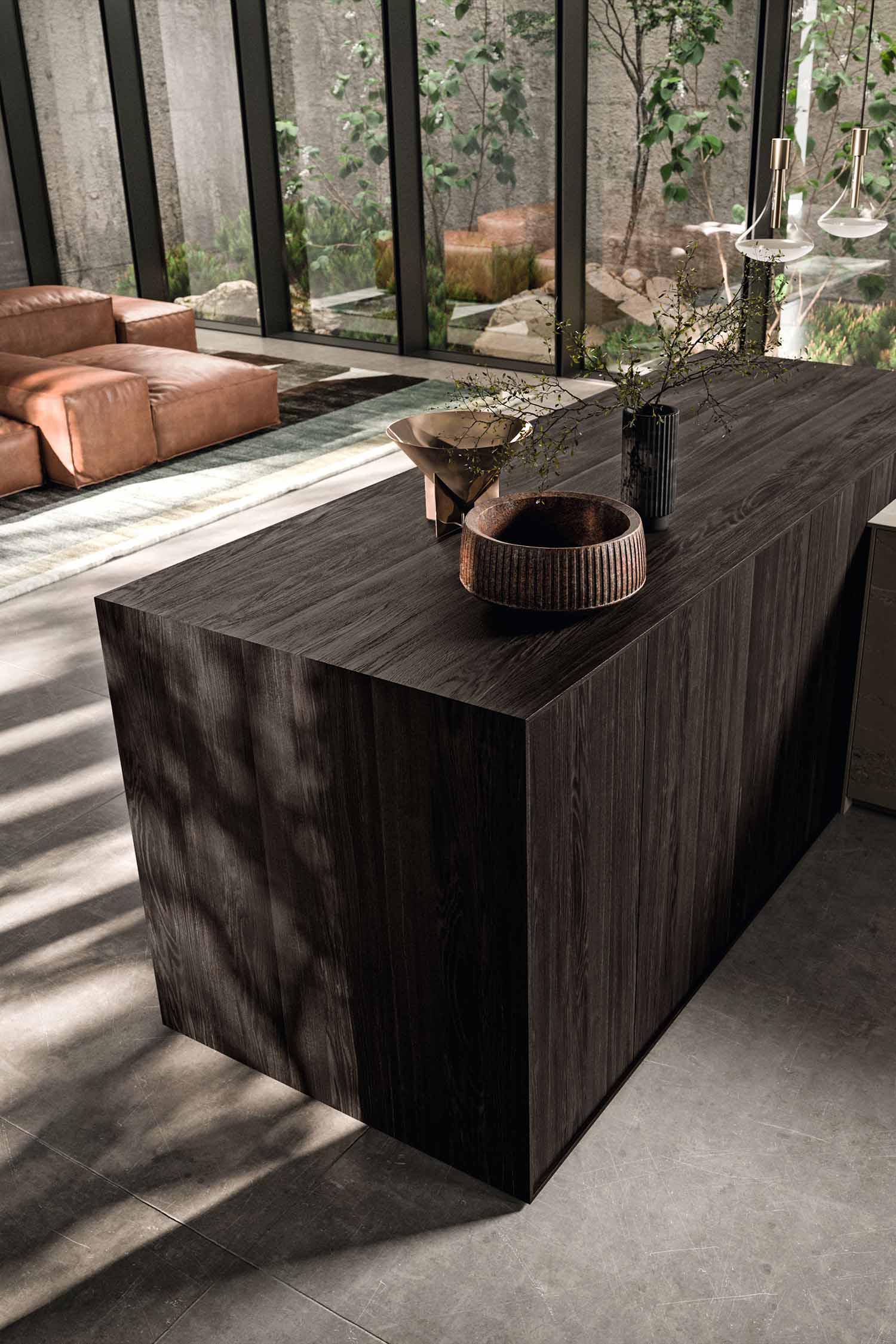 A view of a built-in oven and microwave unit. The black glass appliances are integrated into a light wood-grain cabinet wall, creating a clean, seamless look.