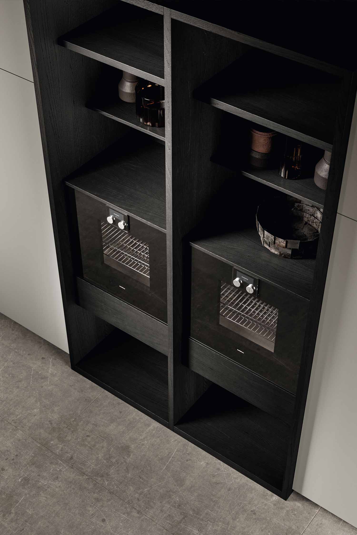 A detailed view of a large, deep kitchen drawer. The drawer is pulled out to show a collection of small white plates, bowls, and other dishes, highlighting the ample storage space.