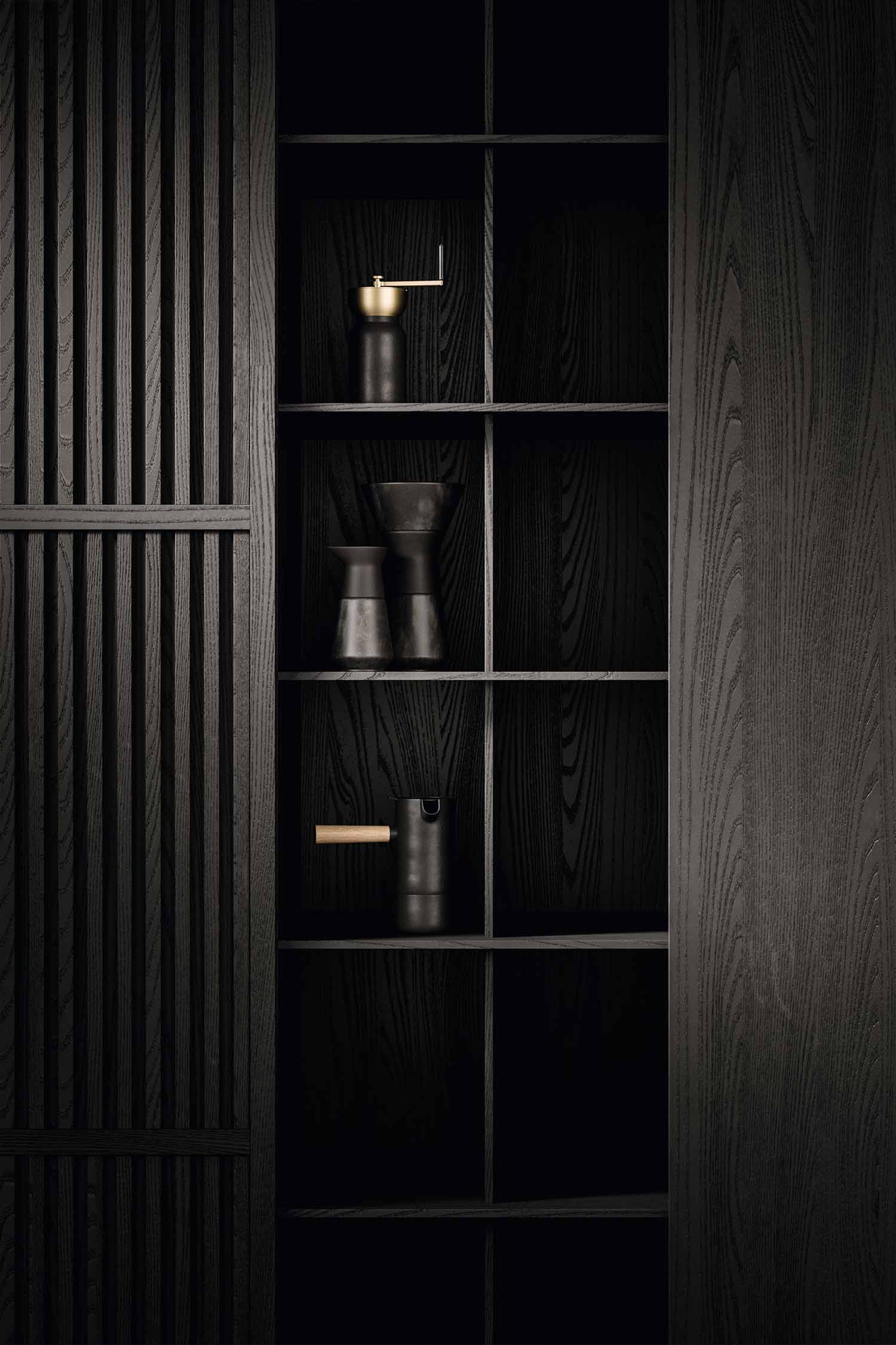 A close-up of a deep kitchen drawer with an integrated waste and recycling system. The drawer is pulled out to show three removable bins for sorting waste, emphasizing the functional design.