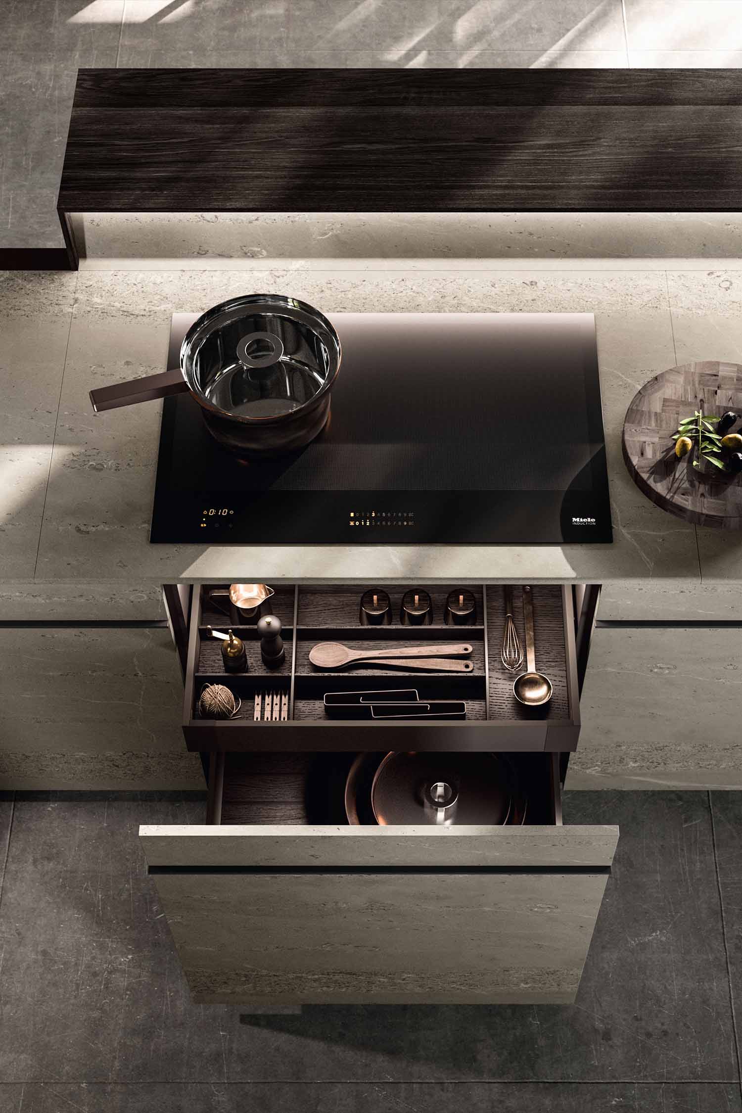 A detailed view of the simple, sleek handles on the minimalist kitchen drawers. The photo shows the thin, horizontal black handle integrated into the top of the white drawer fronts.
