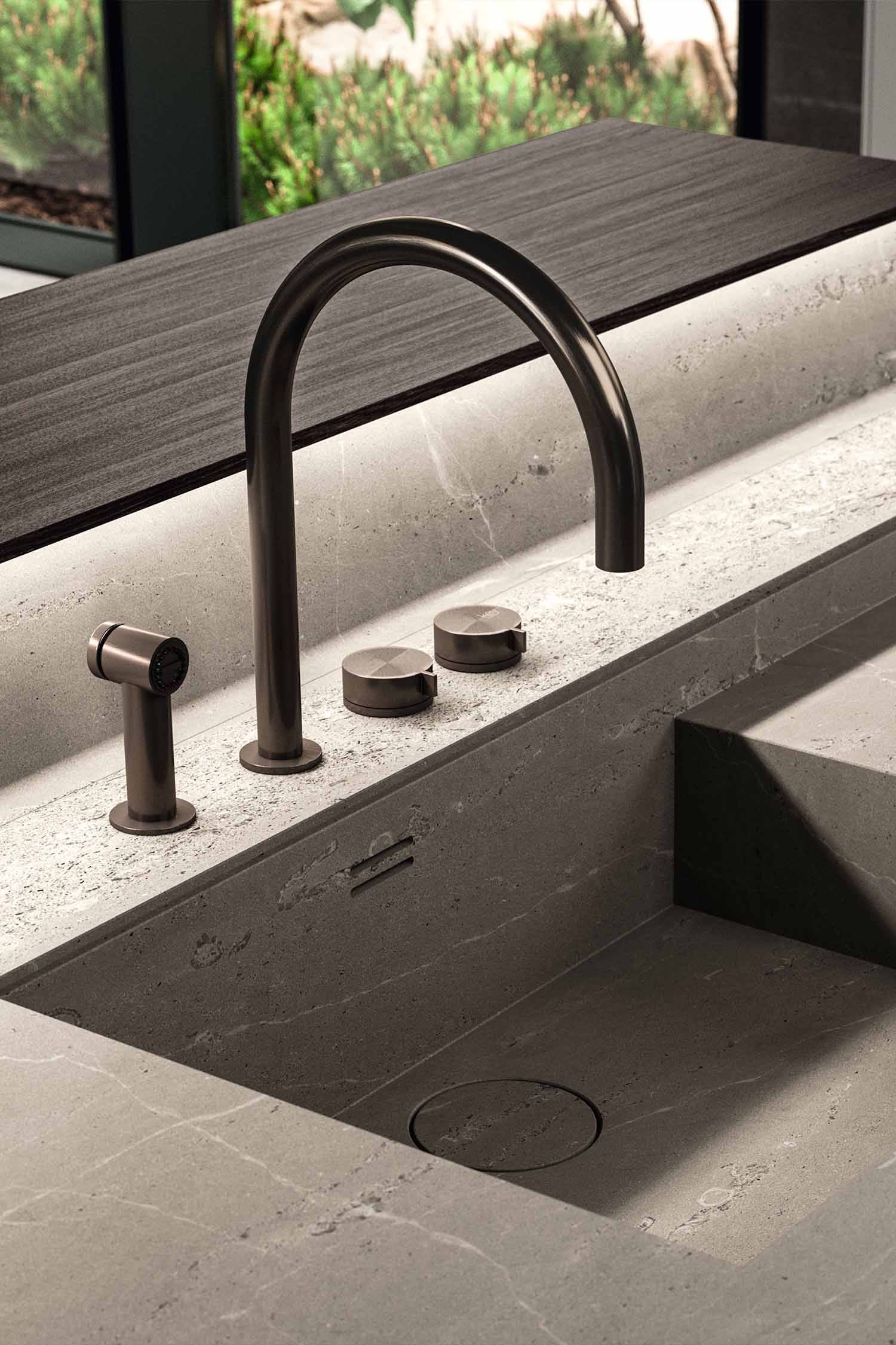 A close-up of the subtle detailing on the kitchen cabinetry. The photo focuses on a small, round metal handle on a drawer, highlighting the refined, minimalist hardware.