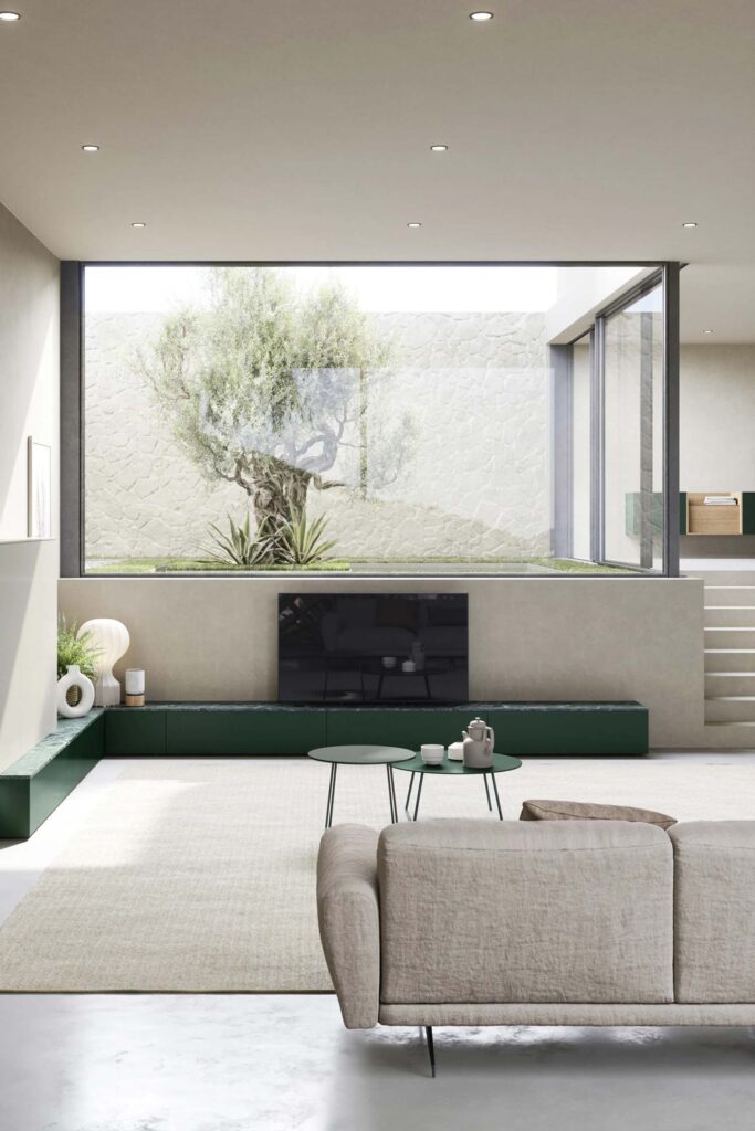 A close-up of a decorative cylindrical bolster pillow on a contemporary sofa. The pillow is made of the same light beige fabric as the sofa and is placed at the end of the seat, emphasising the clean, rounded lines of the furniture.