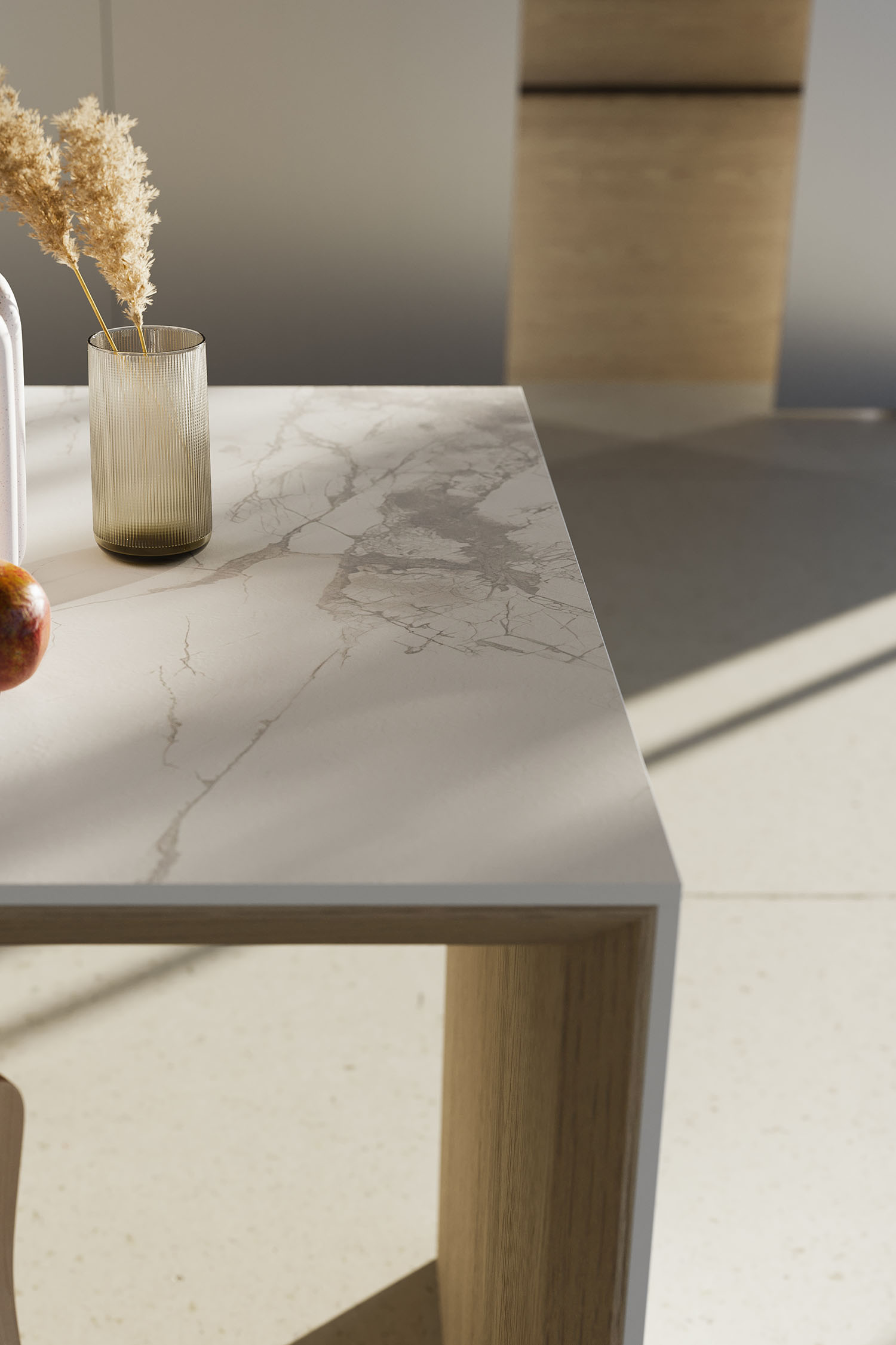 A close-up detail of a minimalist kitchen drawer's interior. The drawer is organized with wooden dividers, showcasing a bespoke solution for cutlery and kitchen tools.
