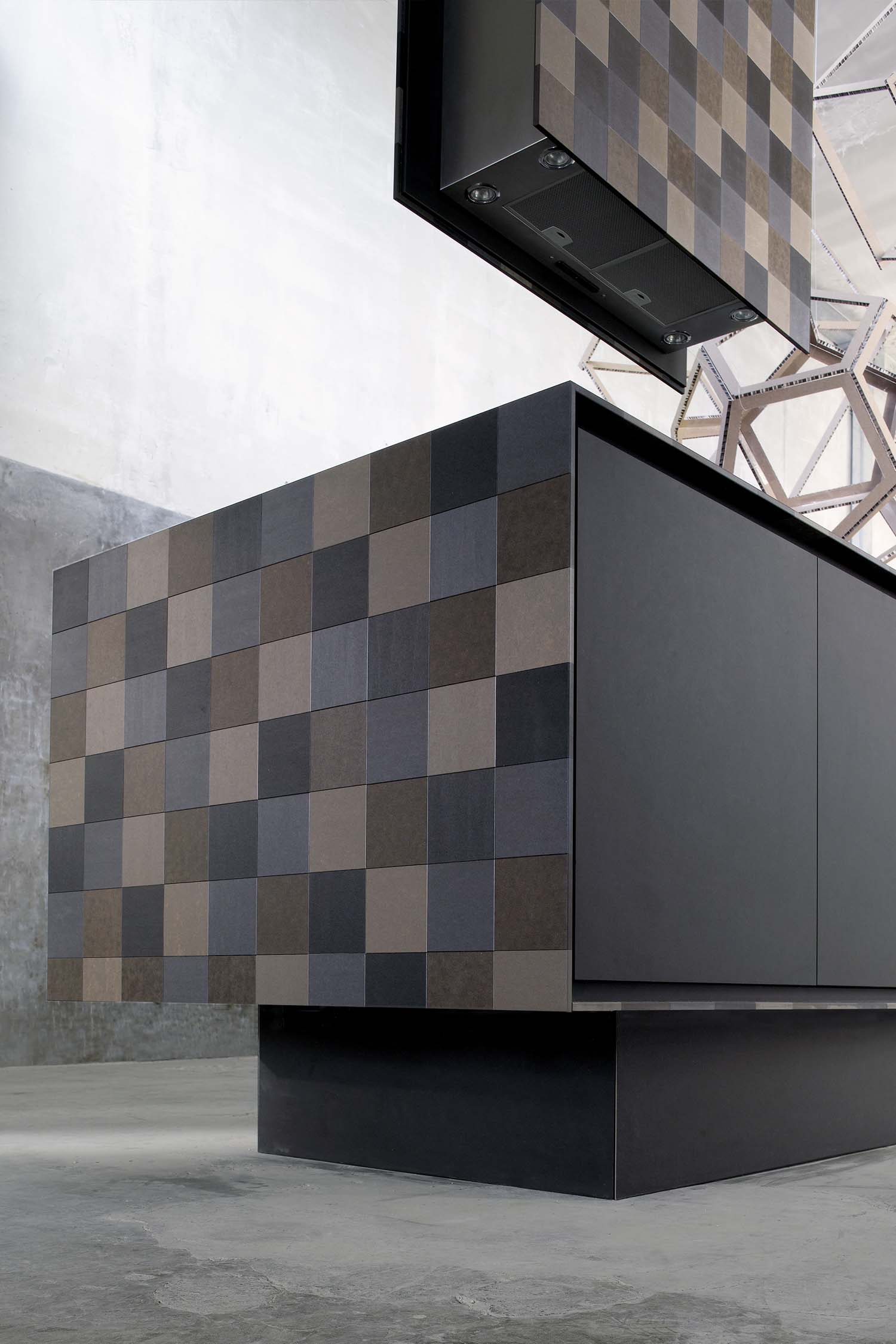 A close-up of a kitchen's built-in oven with a sleek, black glass front, seamlessly integrated into a tall unit.