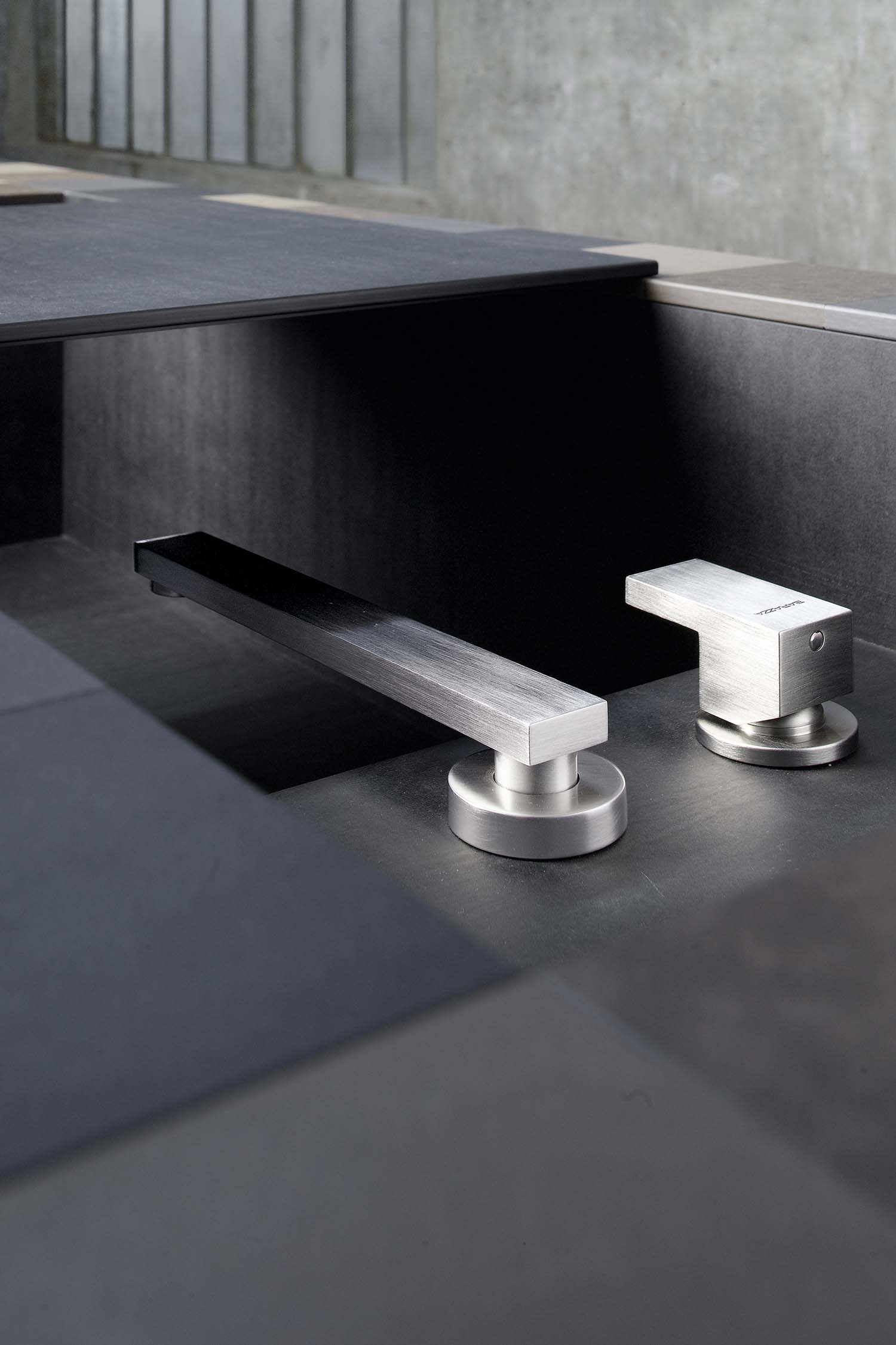 A detail shot of a kitchen's open interior, revealing a light-colored wooden interior with a bespoke cutlery tray and dividers.