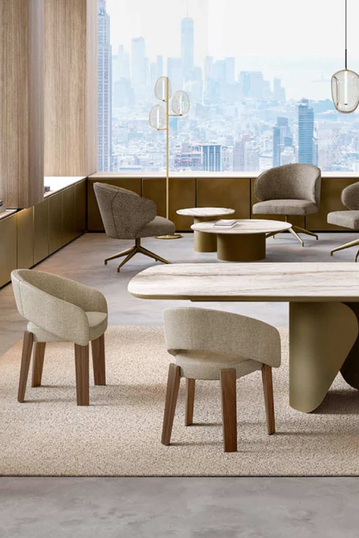 A dining chair with light-colored fabric upholstery and dark wooden legs. The chair is positioned in the foreground of a modern office or dining space, with a large dining table and other chairs visible in the background against a city skyline.