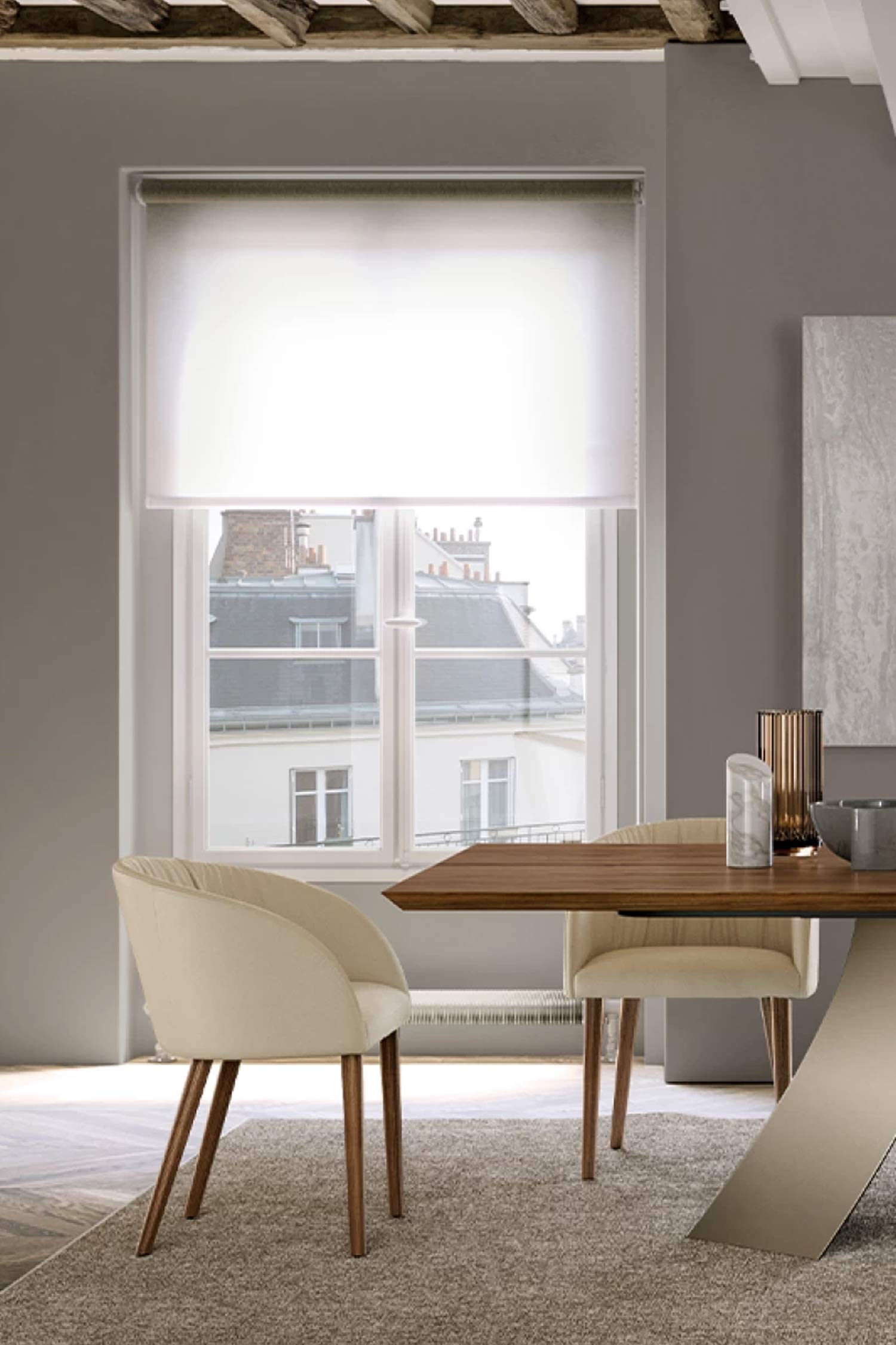 Close-up of a Vulcano luxury dining chair in cream/beige upholstery and wooden legs, paired with a modern dining table in a contemporary dining room setting.