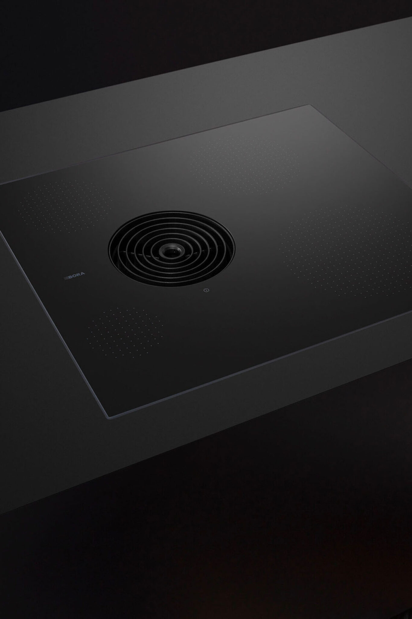 Grey countertop with two pans simmering on a BORA Pure hob and steam drawn into the vent.