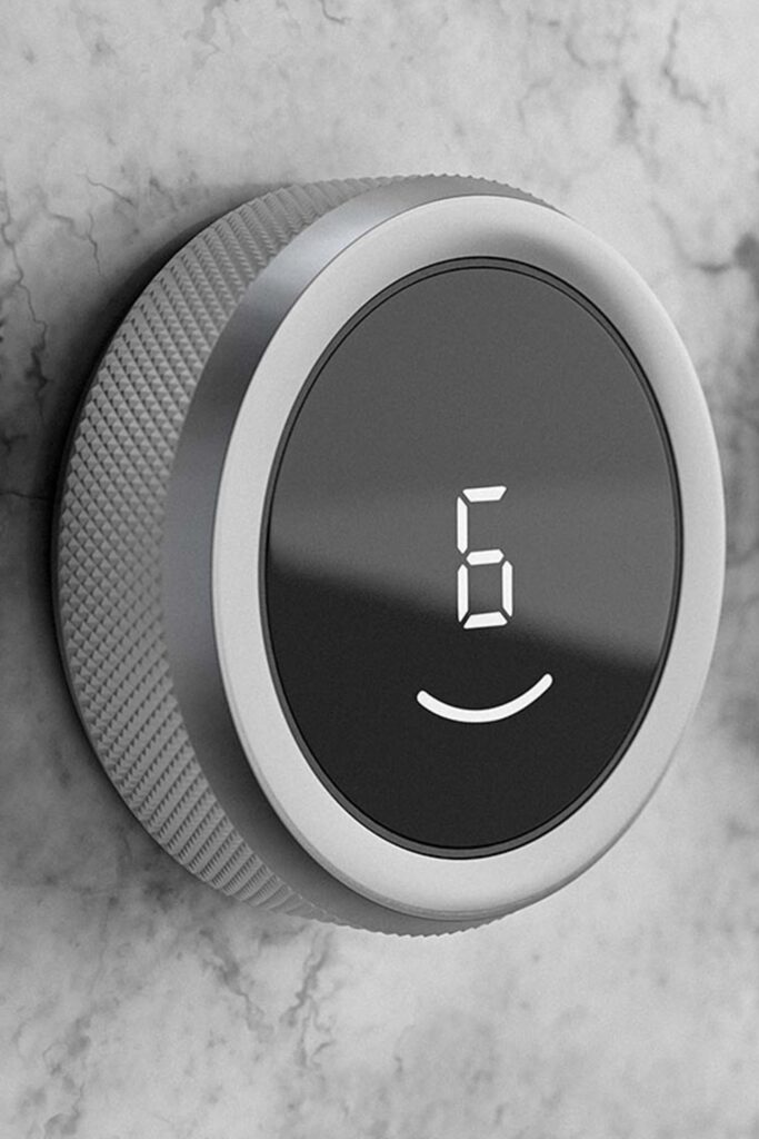 Close-up of a BORA Professional stainless control knob glowing red on a dark glass cooktop.