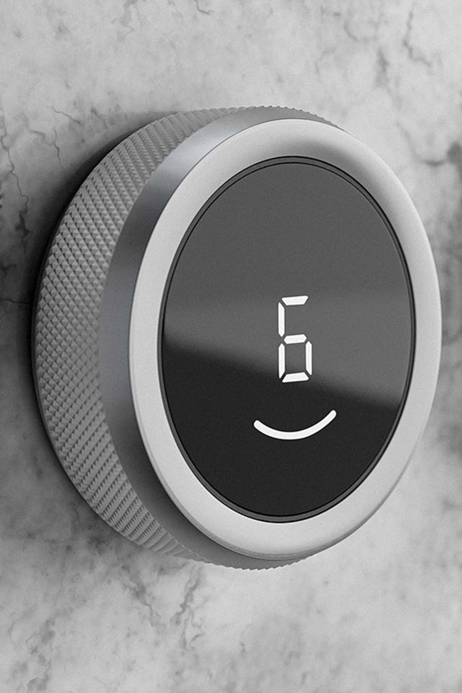 Close-up of a BORA Professional stainless control knob glowing red on a dark glass cooktop.