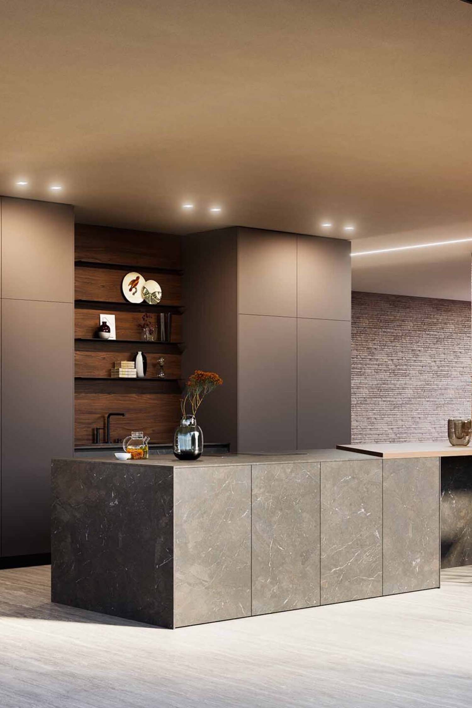 Handleless luxury kitchen with integrated Gaggenau appliances and floor-to-ceiling glazing in Chislehurst home by Krieder Studio