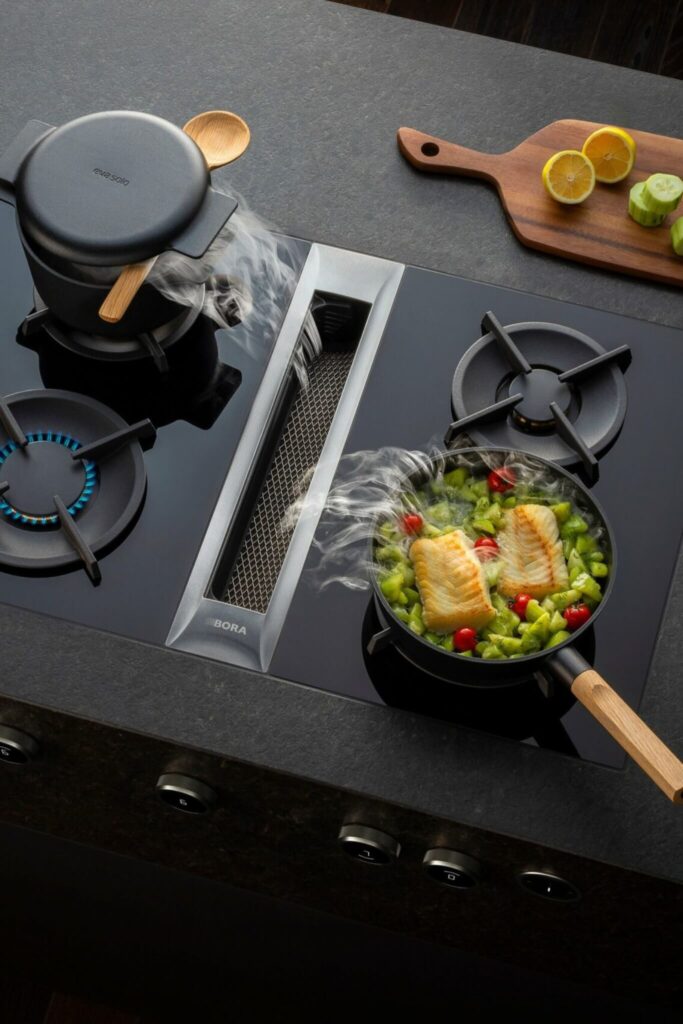 Close-up of sleek stainless control knob on BORA Professional cooktop surface.