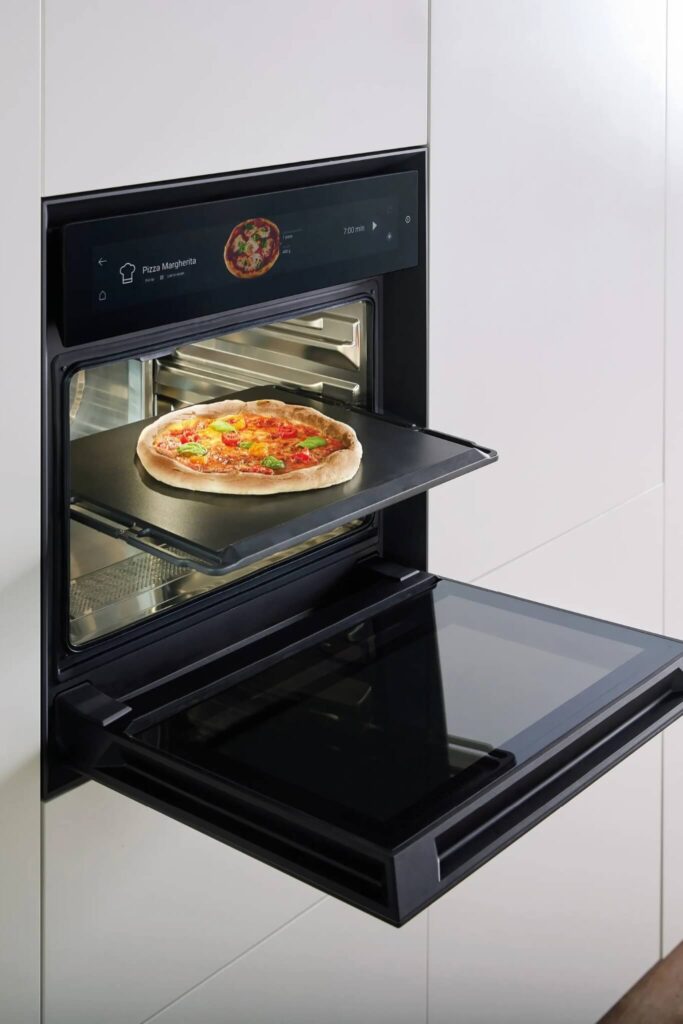 BORA XBO oven built into stone island cooking a pizza.