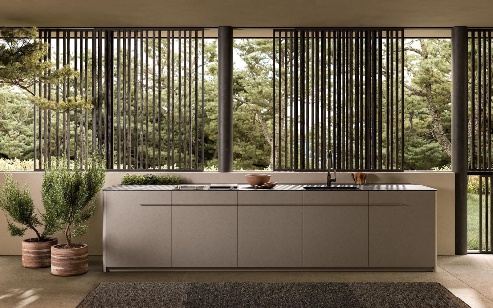 Luxury kitchen with panoramic glazing overlooking a forest, designed for calm, light-filled living